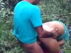 Black Dominican Couple Fucking in the field of greenery.